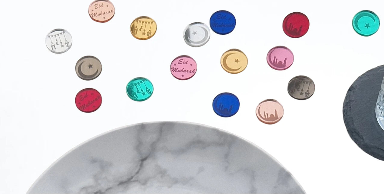 A selection of the Eid Mubarak table confetti on a table with a plate and coaster.