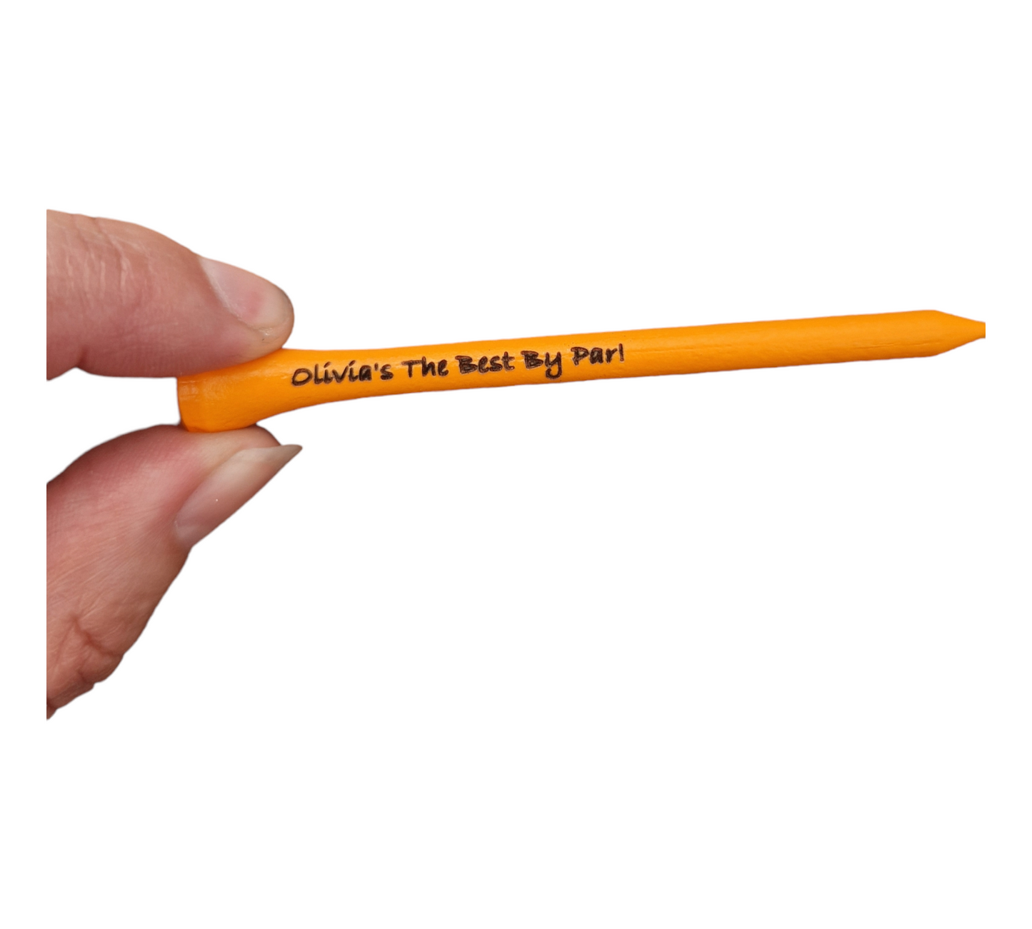 One neon orange golf tee with the text "Olivia's The Best By Par!" laser engraved into it being held between a thumb and finger