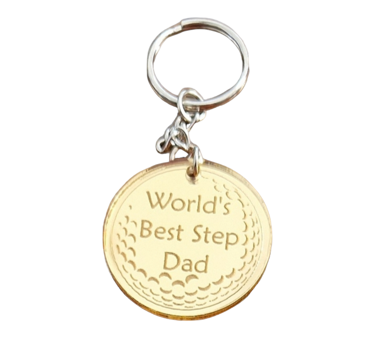 Gold mirror acrylic circle with the partial image of a golf ball with the text "World's Best Step Dad". Attached to the circle is a metal keychain.