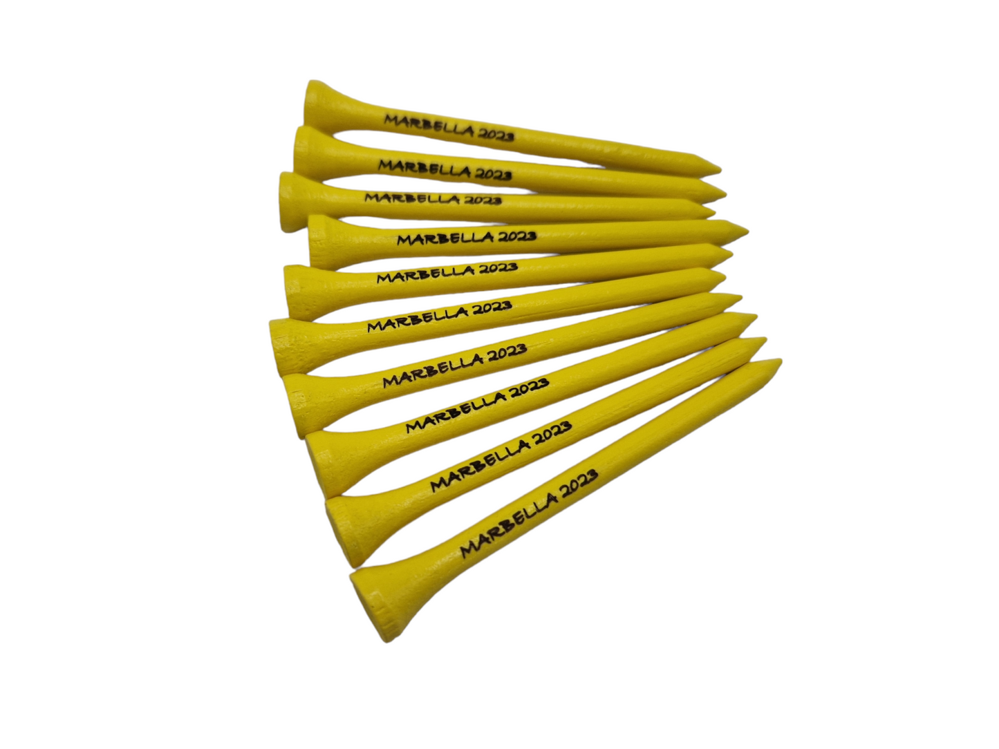 Yellow golf tees laser engraved with the text "MARBELLA 2023"