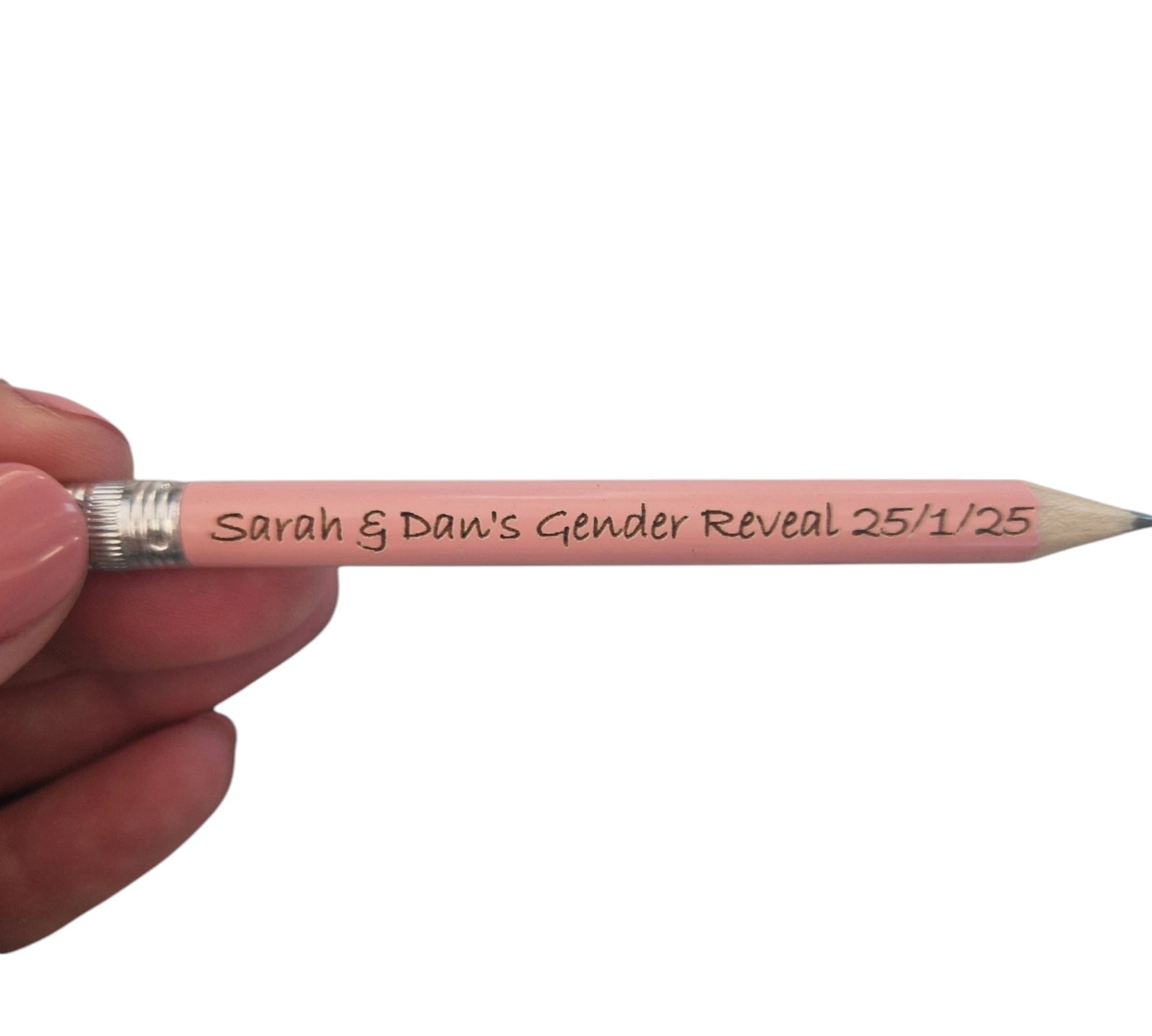 A hand holding a light pink mini pencil with the text "Sarah & Dan's Gender Reveal 25/1/25" laser engraved into it.