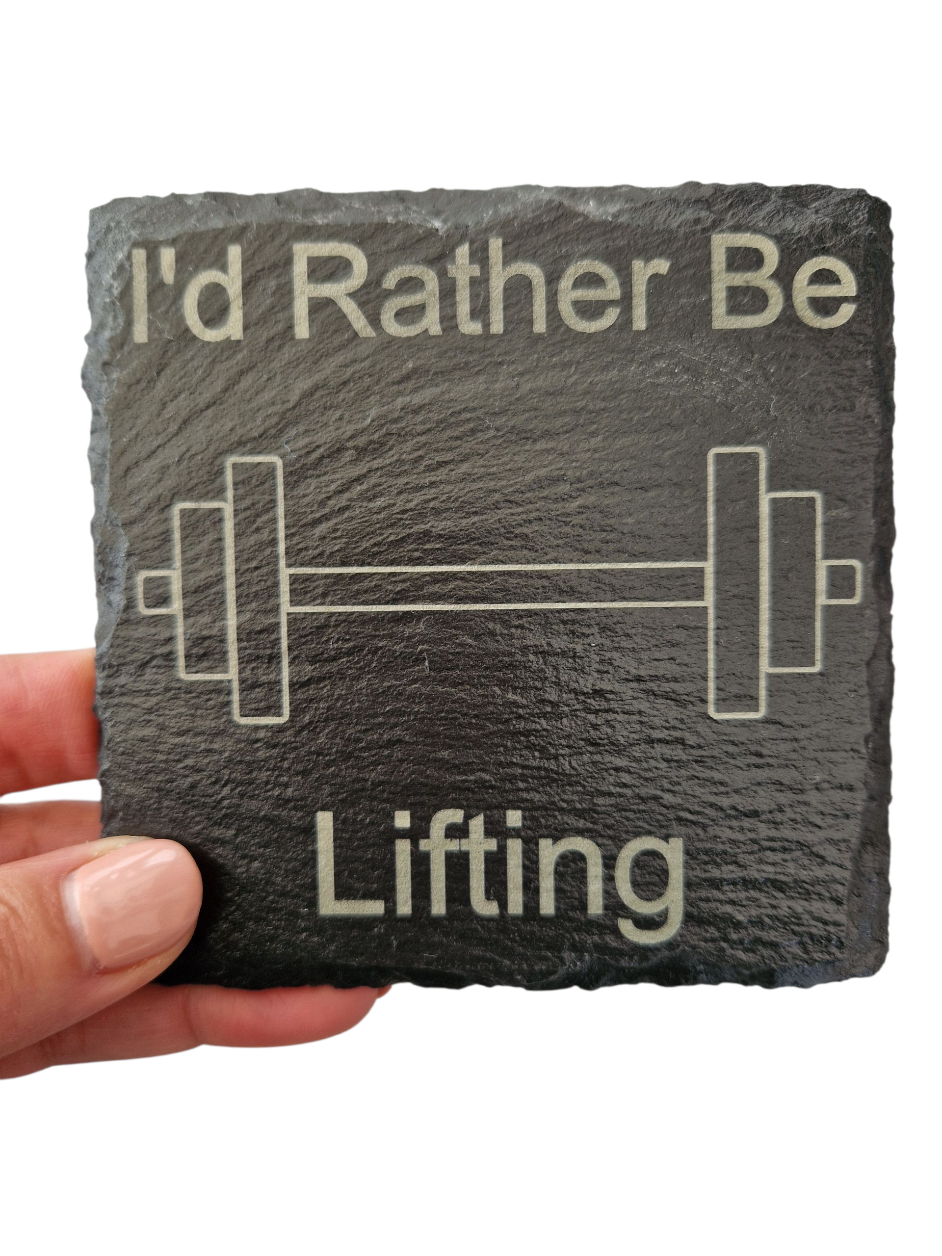A hand holding a square slate coaster with the text "I'd Rather Be Lifting" and the image of a barbell in the centre of the coaster. 