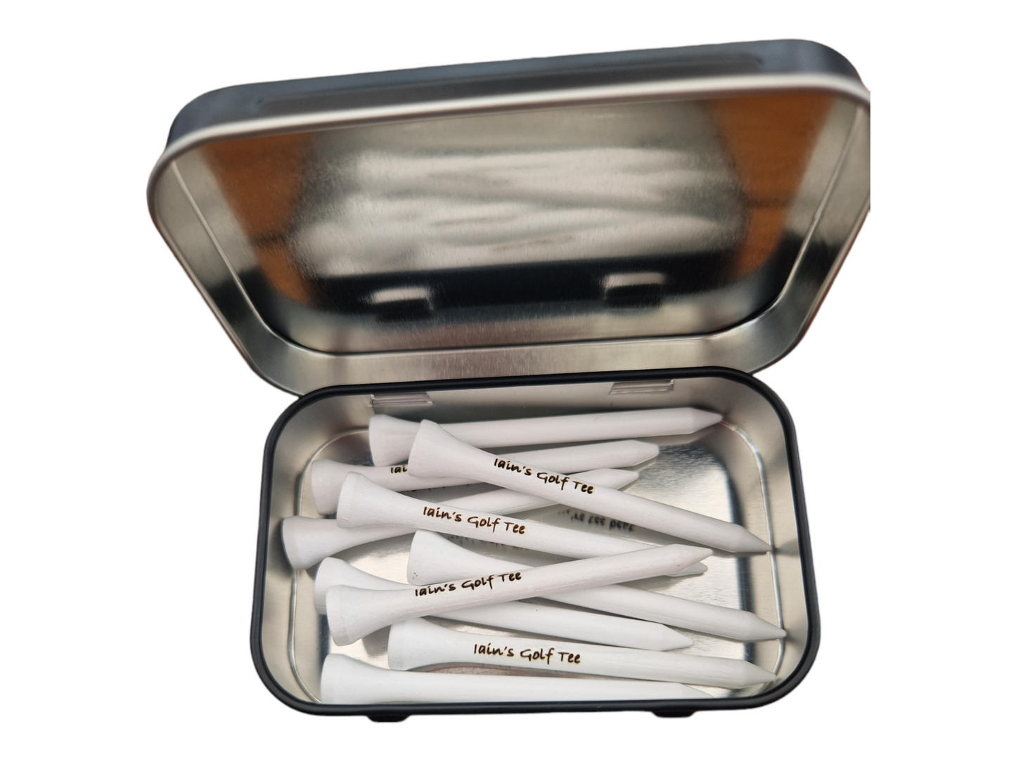 An open tin with 10 white 70mm golf tees laser engraved with the text "Iain's Golf Tee"