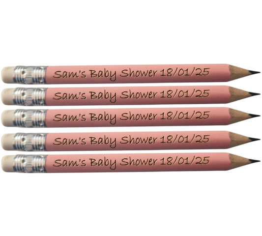 5 light pink mini pencils with the text "Sam's Baby Shower 18/01/25" laser engraved into them.