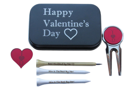 A black tin with "Happy Valentine's Day" and the outline of a heart engraved into it. Natural pencil shaped like a golf tee with the text "Best Husband by Par!" and the outline of a heart engraved into it. 70mm tees with "Iain Is The Best By Par!" engraved into them, a metal pitch repairer with a red mirror acrylic circle at the top with "IU" and a heart engraved into the outline of a heart. A red heart shaped ball marker with "IU" and a heart engraved into it