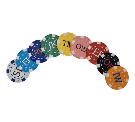 White poker chip ball marker with black vinyl initials, pale blue poker chip with matte silver initials, royal blue poker chip with orange initials, green poker chip with white initials, yellow poker chip with black initials, pink poker chip with black initials, red poker chip with white initials, black poker chip with party pink initials, orange poker chip with blue initials