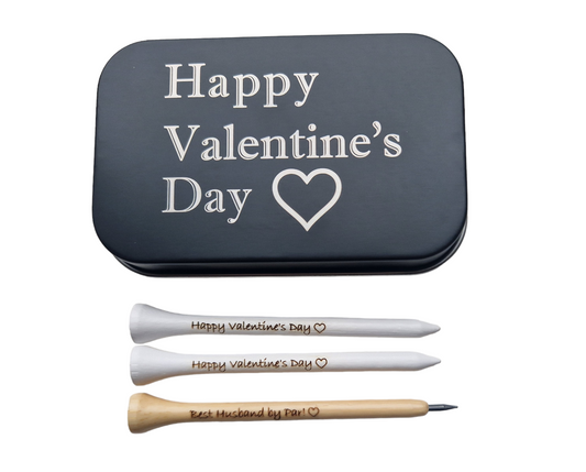 2x83mm white golf tees with the text "Happy Valentine's Day" and an outline of a heart laser engraved into them. 1 x novelty golf tee pencil with the text "Happy Valentine's Day" and an outline of a heart laser engraved into it. 
1 x black metal tin with "Happy Valentine's Day" and an outline of a heart laser engraved into it. 