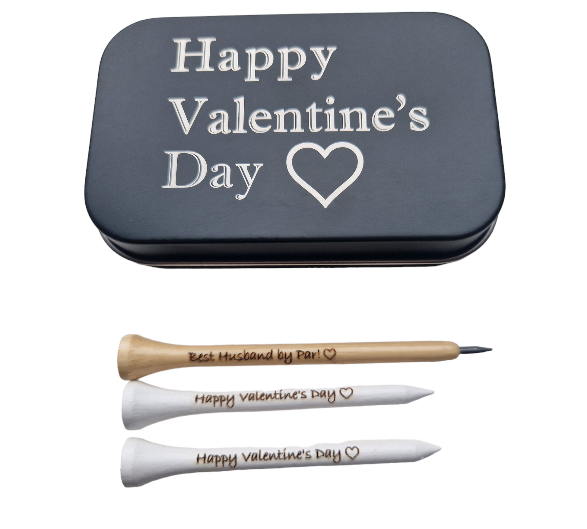 2x70mm white golf tees with the text "Happy Valentine's Day" and an outline of a heart laser engraved into them. 1 x novelty golf tee pencil with the text "Happy Valentine's Day" and an outline of a heart laser engraved into it. 
1 x black metal tin with "Happy Valentine's Day" and an outline of a heart laser engraved into it. 