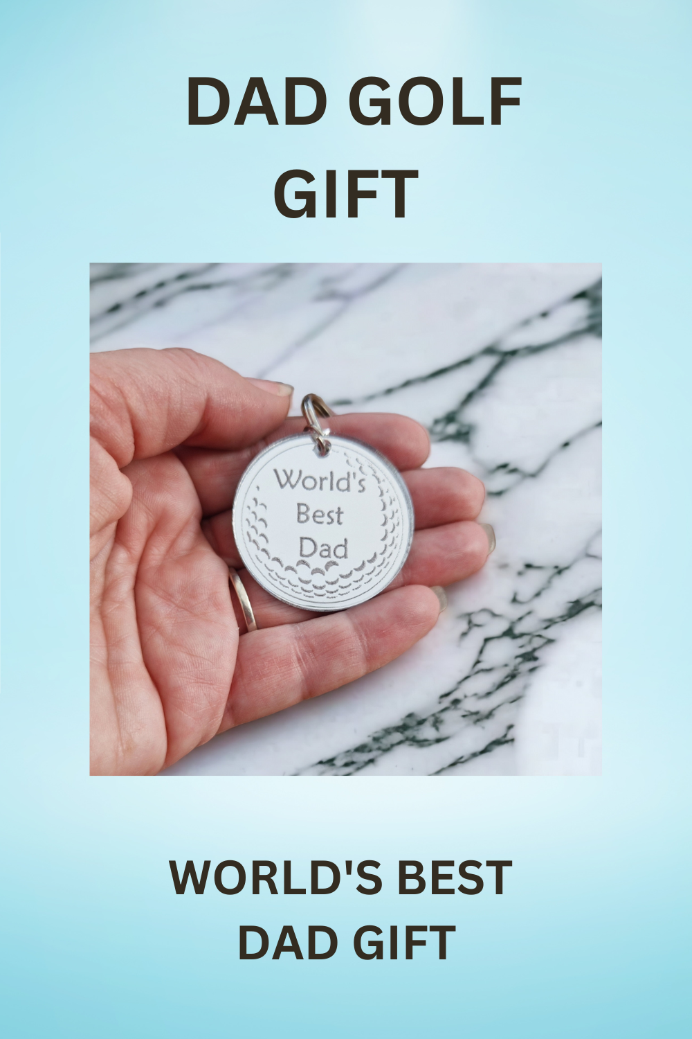 Blue background With the text "DAD GOLF GIFT" at the top and "WORLD'S BEST DAD GIFT" at the bottom with the image of the keyring being held in the centre. This image is suitable  for pinning to Pinterest.