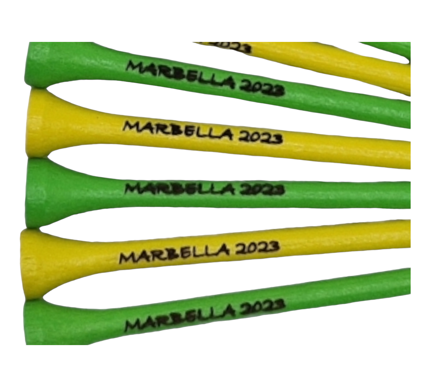 green and yellow golf tees with the text "MARBELLA 2023" laser engraved into them