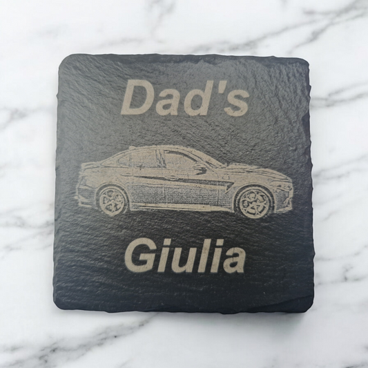 Square slate coaster featuring the text "Dad's" at the top of the coaster and "Giulia" at the bottom of the coaster. In the centre of the coaster is a laser engraved image of a car.