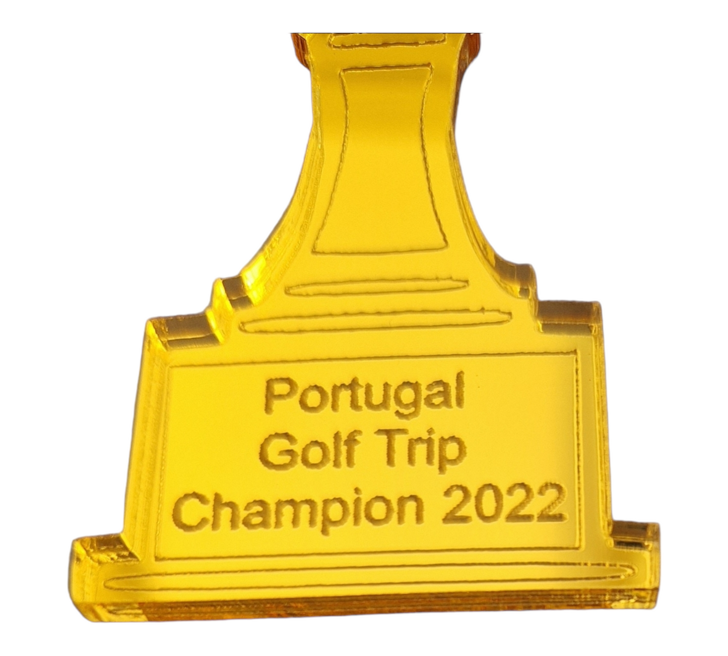 Close up of the bottom of the gold golf bag trophy showing the text "Portugal Golf Trip Champion 2022"