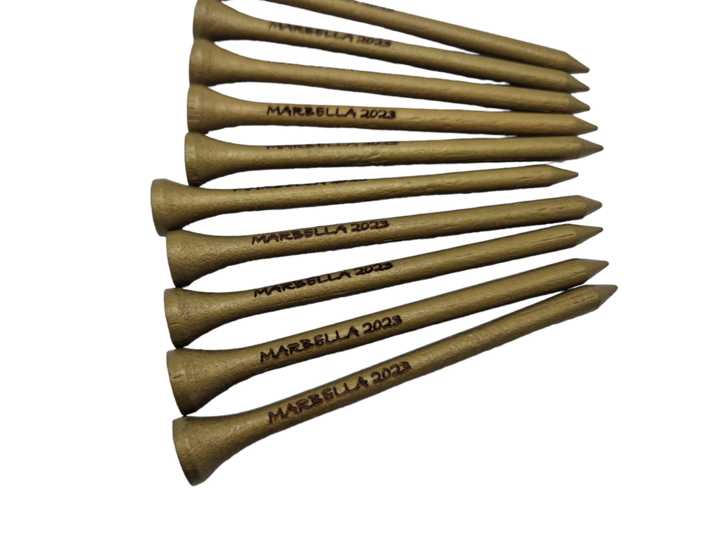 Gold golf tees with the text "MARBELLA 2023" laser engraved into them